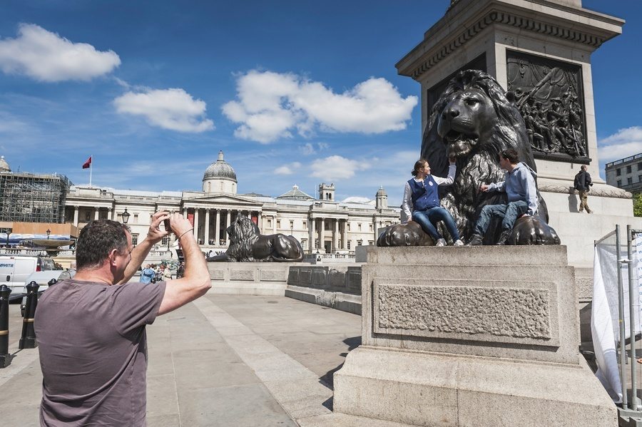 London tourists in Trafalgar Square UK